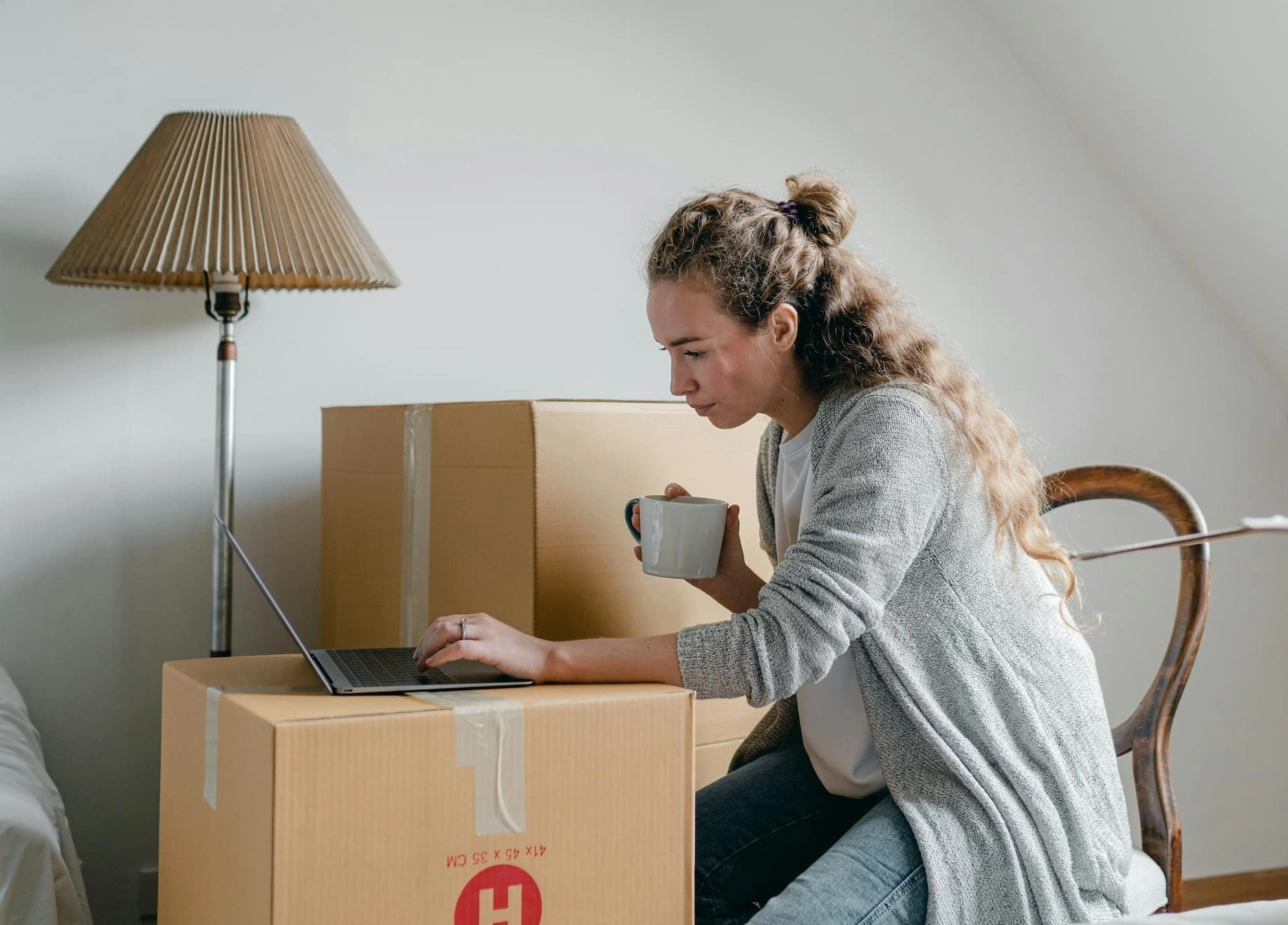 people on their computers surrounded by moving boxes