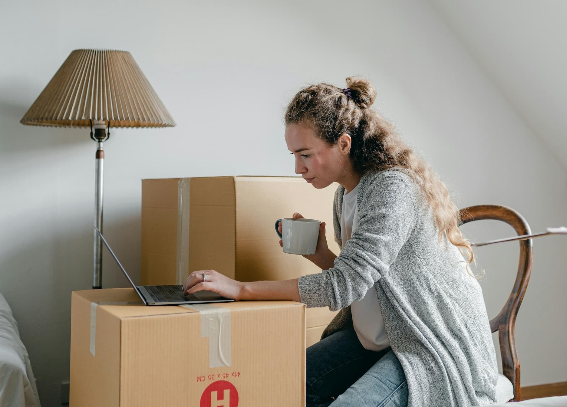 people on their computers surrounded by moving boxes